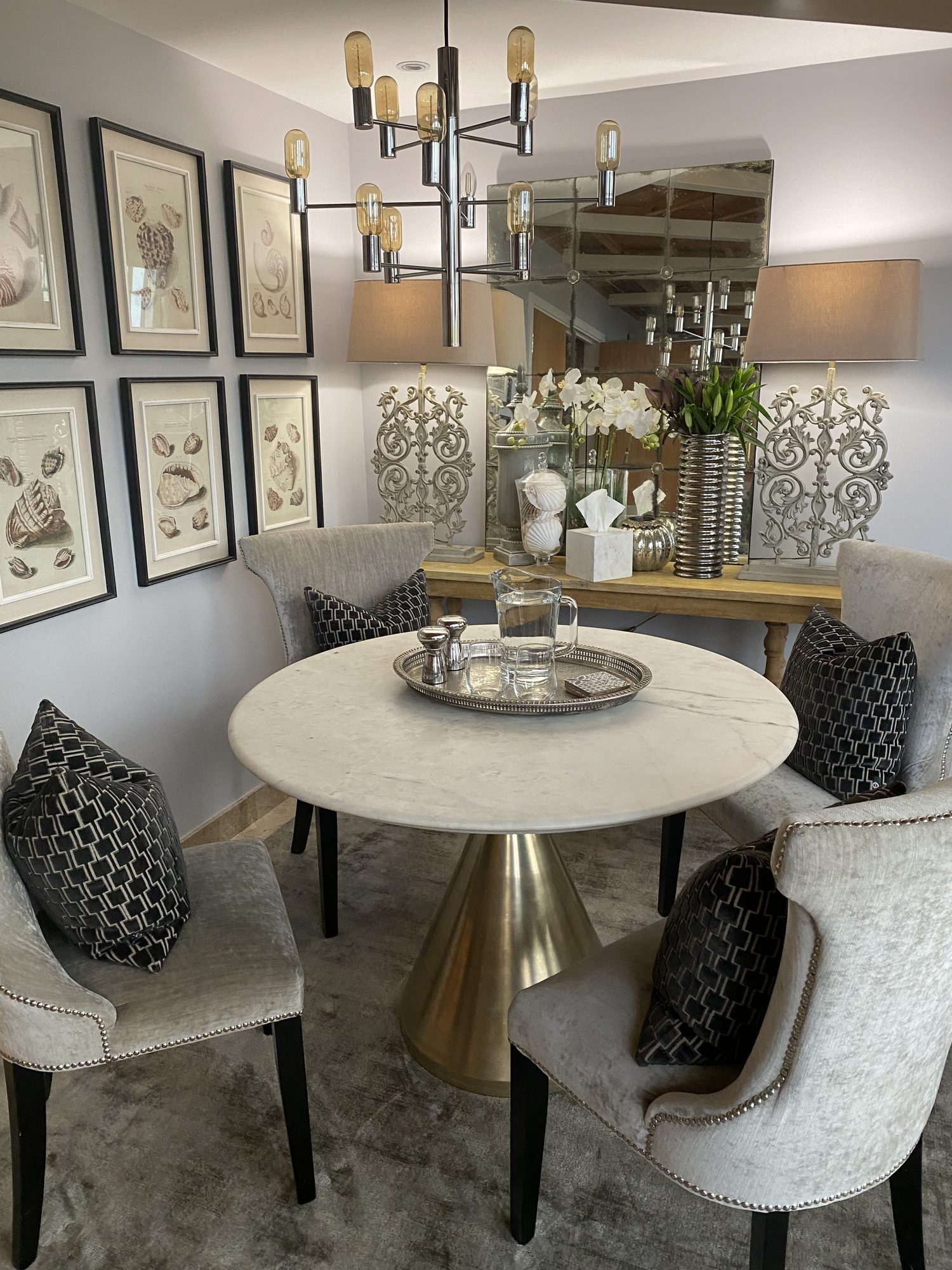 Dining area with marble pedestal table and gallery wall